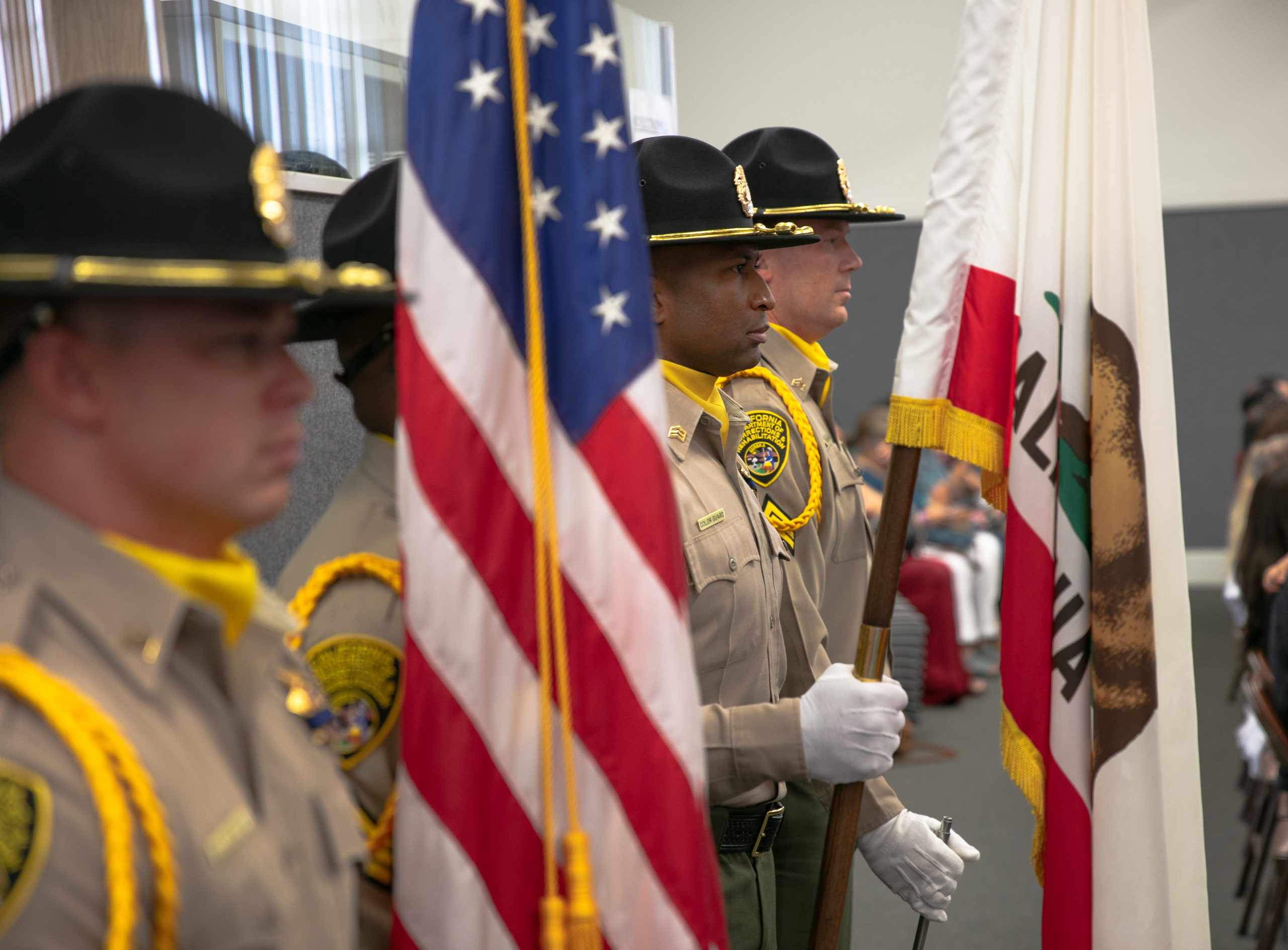 CDCR Sergeants standing at attention at a graduation ceremony.